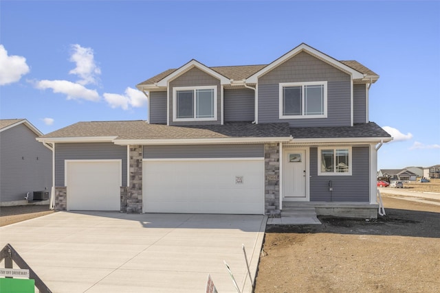 view of front of house with a garage and cooling unit