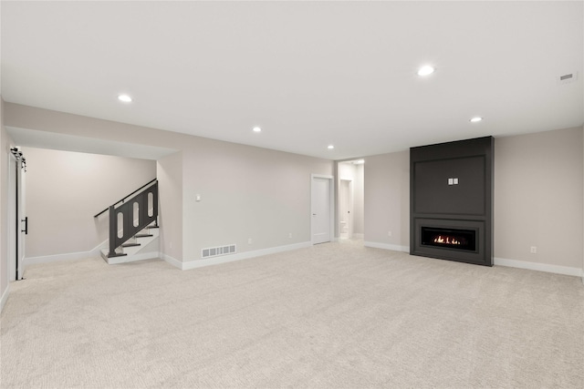 1129 NW 28th St, Grimes, IA 50111 - finished basement featuring light colored carpet, stairway, recessed lighting, and a fireplace