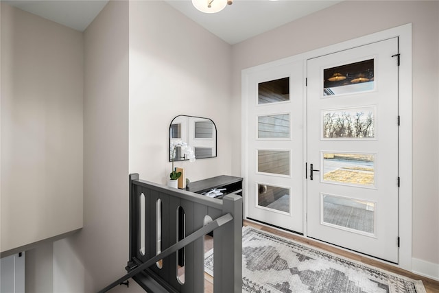 foyer entrance with hardwood / wood-style flooring and french doors