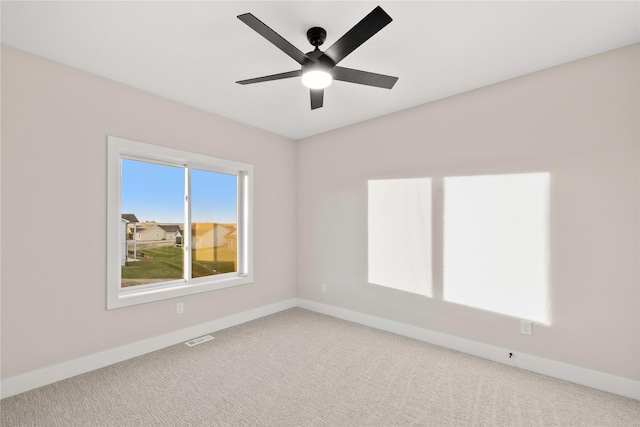 1129 NW 28th St, Grimes, IA 50111 - empty room featuring carpet floors and a ceiling fan