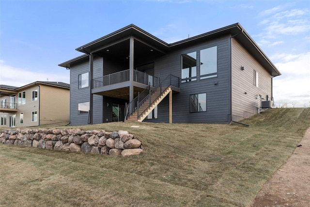 1129 NW 28th St, Grimes, IA 50111 - back of house featuring stairs, a yard, and a deck