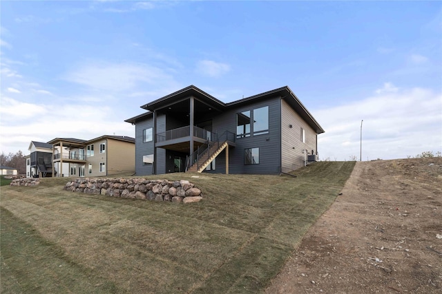 1129 NW 28th St, Grimes, IA 50111 - rear view of house with stairs and a lawn