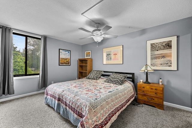 carpeted bedroom with a textured ceiling and ceiling fan