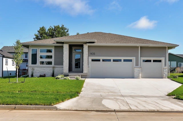 prairie-style house with a front lawn and a garage