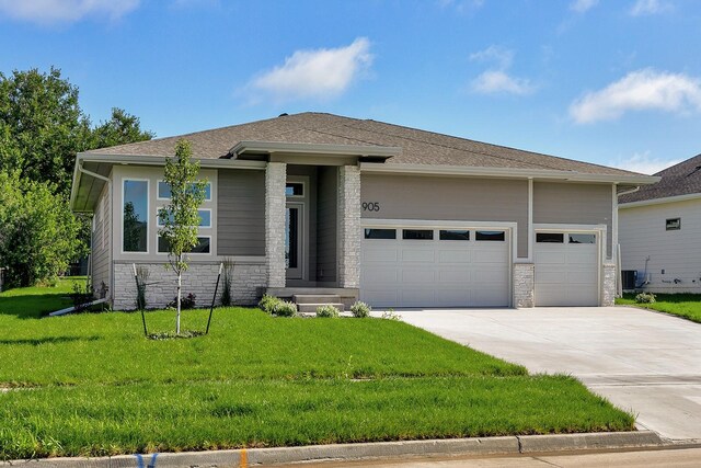 prairie-style home featuring a front lawn