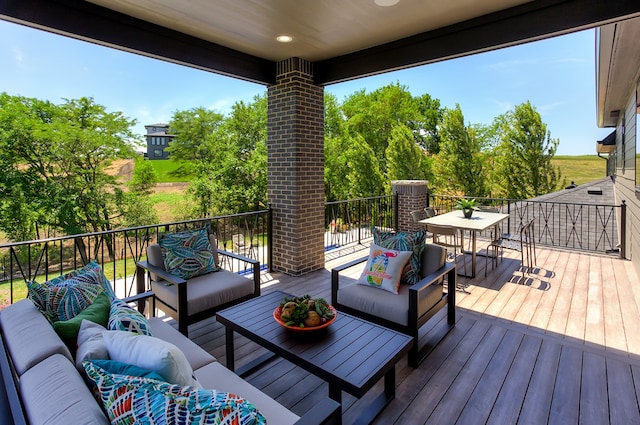 wooden terrace with an outdoor living space