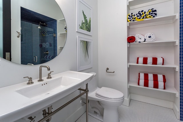 bathroom with walk in shower, toilet, vanity, and tile patterned floors