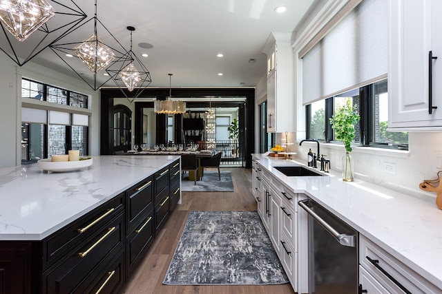 kitchen featuring decorative light fixtures, white cabinets, dishwasher, and a healthy amount of sunlight