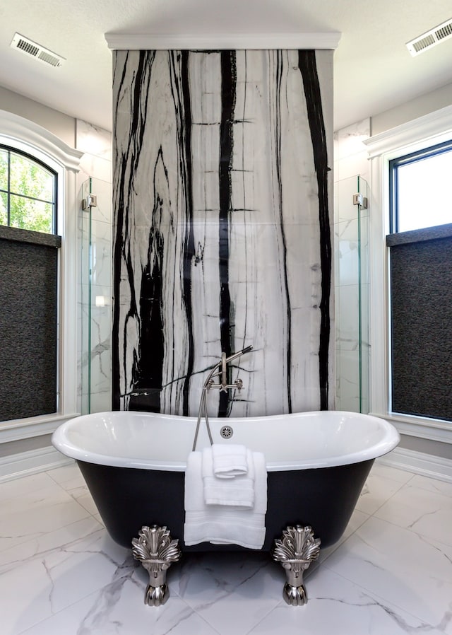 bathroom featuring independent shower and bath