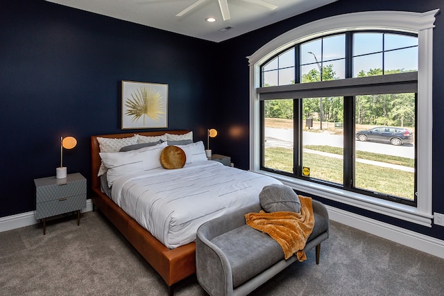 carpeted bedroom featuring ceiling fan and multiple windows