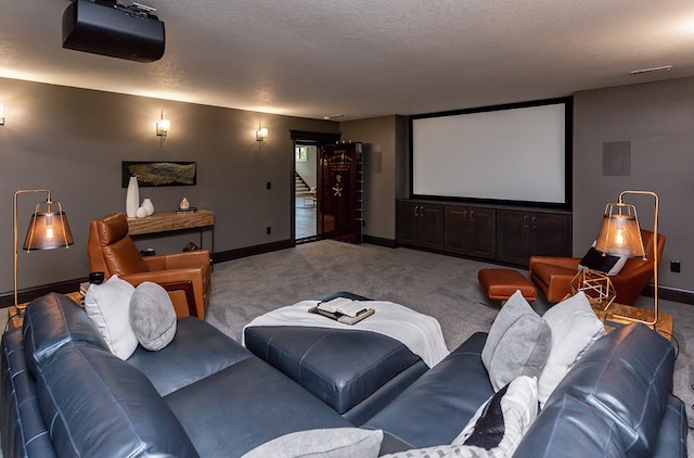 cinema room featuring a textured ceiling and light colored carpet