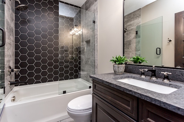 full bathroom featuring shower / bath combination with glass door, toilet, and vanity