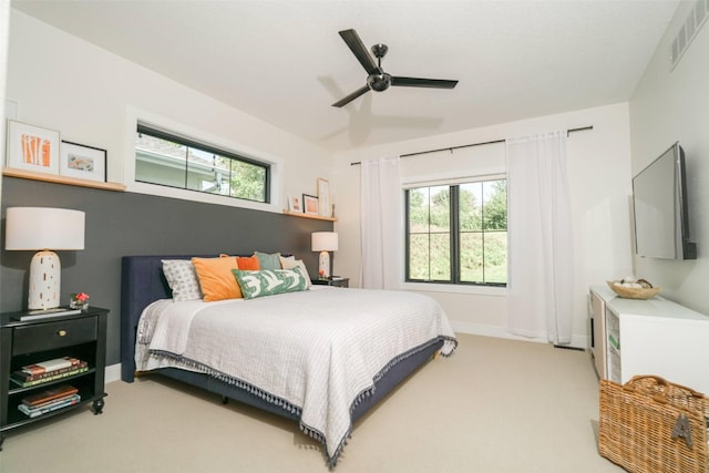 bedroom featuring carpet flooring, multiple windows, and ceiling fan