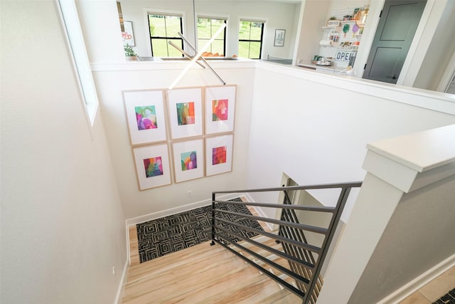 stairs featuring hardwood / wood-style flooring