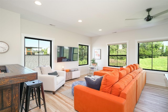 living room with ceiling fan and light wood-type flooring