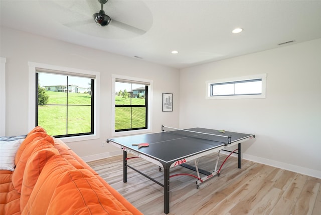 game room with light hardwood / wood-style flooring and ceiling fan