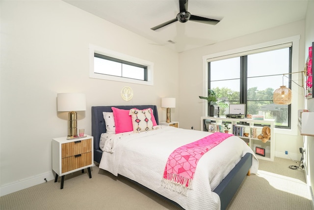 carpeted bedroom featuring ceiling fan and multiple windows