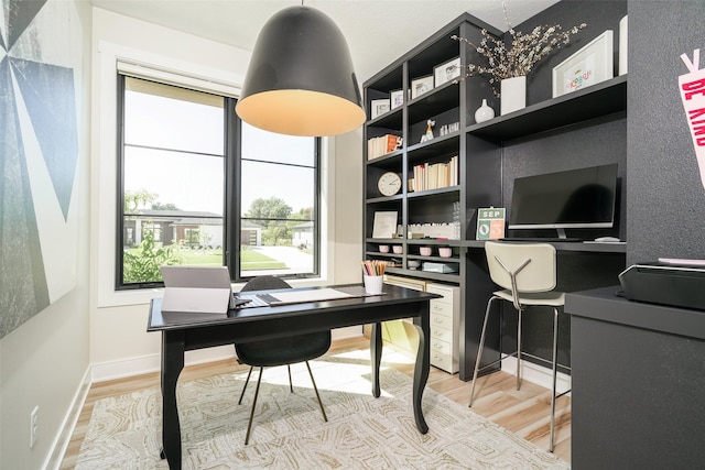 home office with hardwood / wood-style flooring