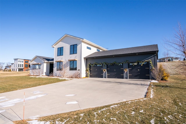 view of front of home with a garage and a front lawn