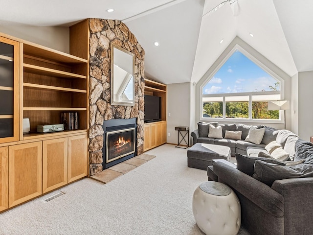 living area featuring lofted ceiling, a stone fireplace, light carpet, visible vents, and built in features