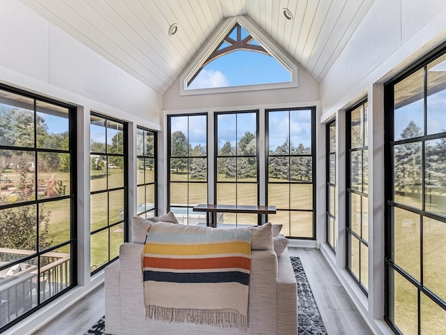 sunroom / solarium featuring wood ceiling, a healthy amount of sunlight, and vaulted ceiling