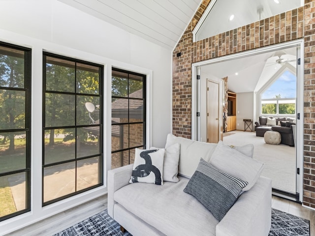 sunroom featuring ceiling fan and vaulted ceiling