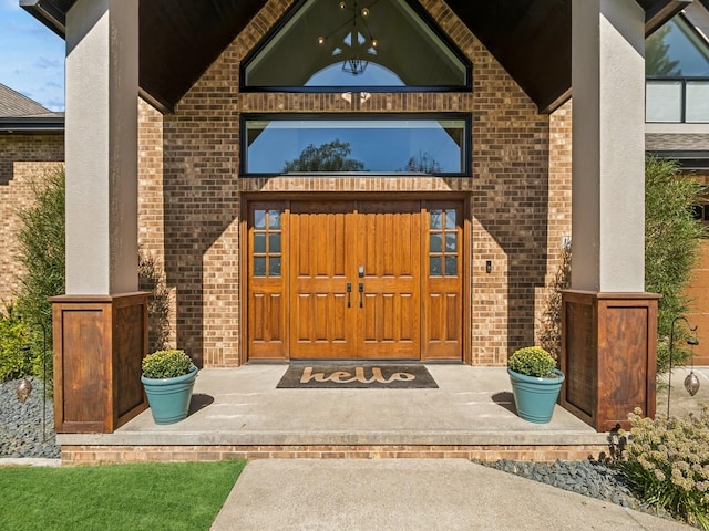 doorway to property featuring brick siding