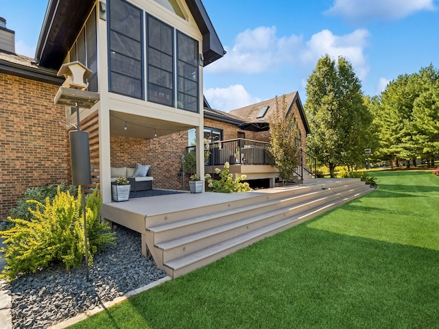 rear view of property featuring a yard, outdoor lounge area, and a wooden deck