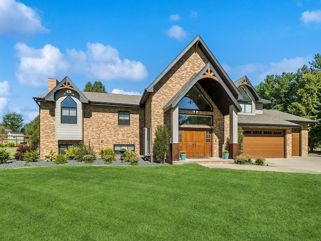 view of front of home with concrete driveway, brick siding, a chimney, and a front yard