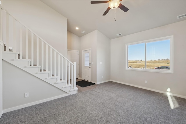 interior space featuring ceiling fan and carpet