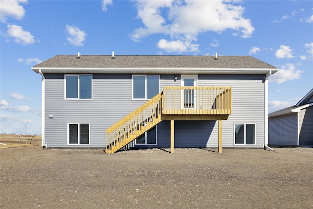 rear view of property with a wooden deck