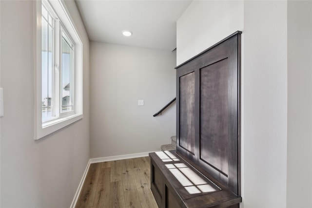 hallway with light hardwood / wood-style floors