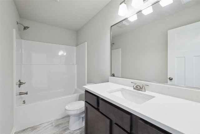 full bathroom with vanity, hardwood / wood-style floors, toilet, and washtub / shower combination