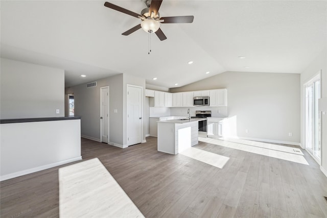 kitchen with white cabinets, a healthy amount of sunlight, and stainless steel appliances