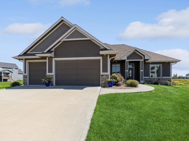 craftsman-style home featuring a garage and a front lawn