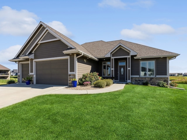 craftsman-style house with a garage and a front lawn