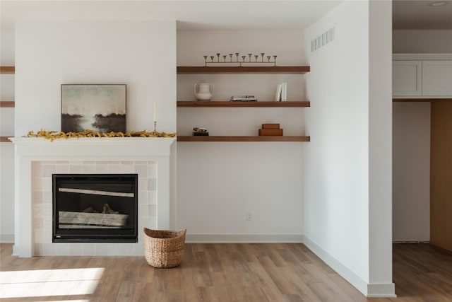 unfurnished living room featuring light hardwood / wood-style floors and a fireplace