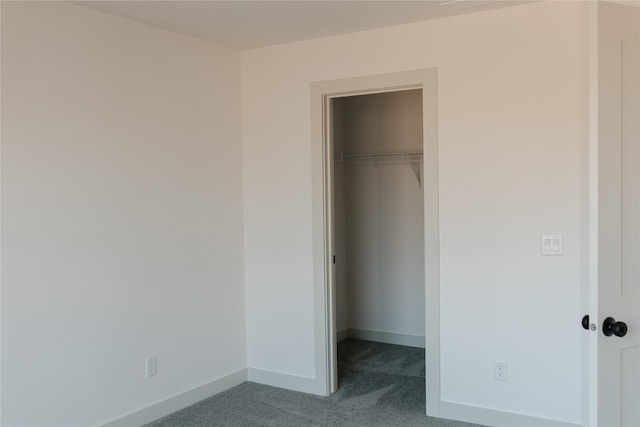 unfurnished bedroom featuring carpet floors and a closet