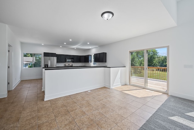 kitchen with stainless steel refrigerator with ice dispenser and light tile patterned flooring