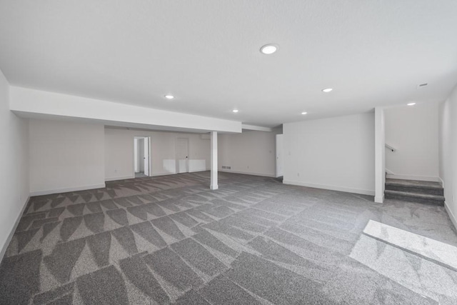 finished below grade area featuring recessed lighting, baseboards, stairs, and carpet