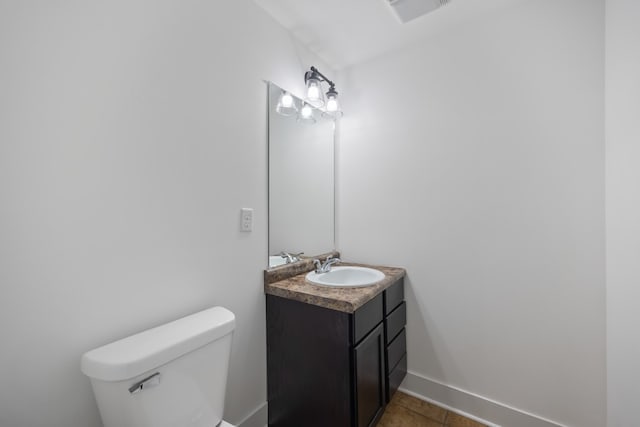 bathroom with vanity, toilet, and tile patterned floors