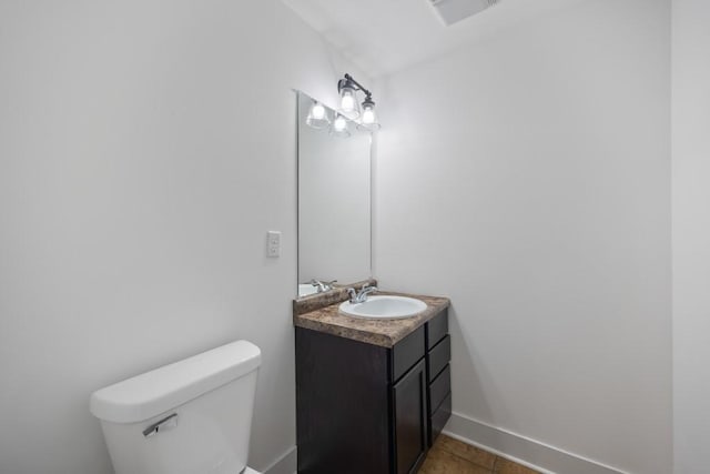 bathroom with visible vents, toilet, vanity, and baseboards