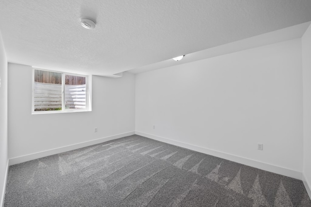 unfurnished room featuring a textured ceiling and carpet