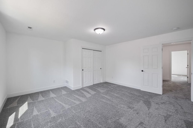 unfurnished bedroom featuring a closet, baseboards, visible vents, and carpet flooring