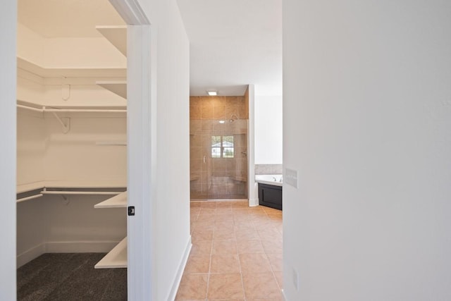 walk in closet with tile patterned floors