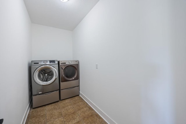 laundry area with washer and dryer, laundry area, and baseboards