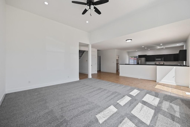 unfurnished living room with baseboards, ceiling fan, stairway, light colored carpet, and recessed lighting