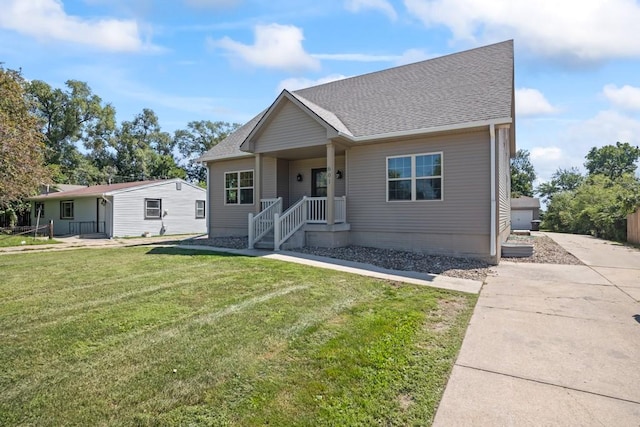 bungalow-style house featuring a front yard and roof with shingles