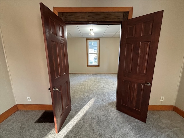 hallway featuring light carpet