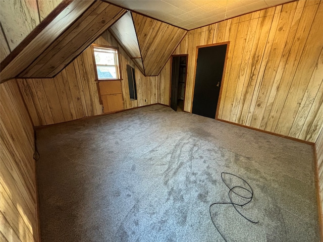 bonus room with lofted ceiling, carpet floors, and wooden walls